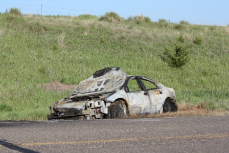 Abandoned vehicle in road ditch