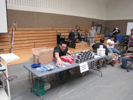 Man arranging materials on table near presentation