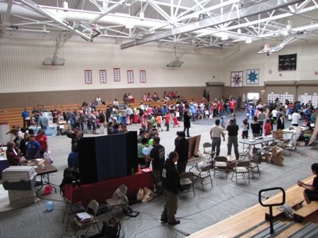 People looking at presentations in a gym