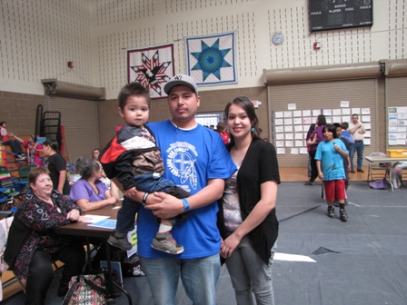 Young family posing for photo in gym